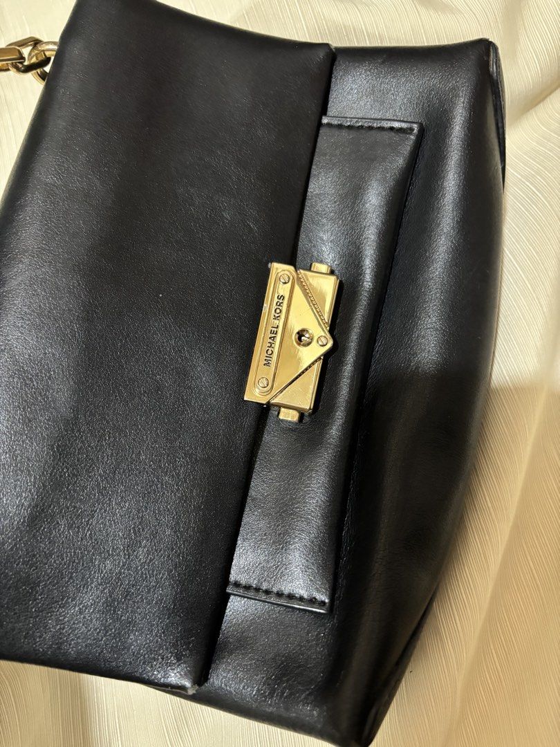 Michael Kors Black Leather Chain Shoulder Bag (Category: Luxury Bags & Wallets) located in Makati City. Submitted by issa124 (Listing ID 1464319245, Image 3). Description: - Authentic Michael Kors black leather shoulder bag - Elegant gold chain strap - Iconic Michael Kors lock closure - Spotless interior - Versatile for day or evening use - Very minimal signs of wear - Ready for its new owner! - Shoulder or hand bag -issue: rubs on all corners as