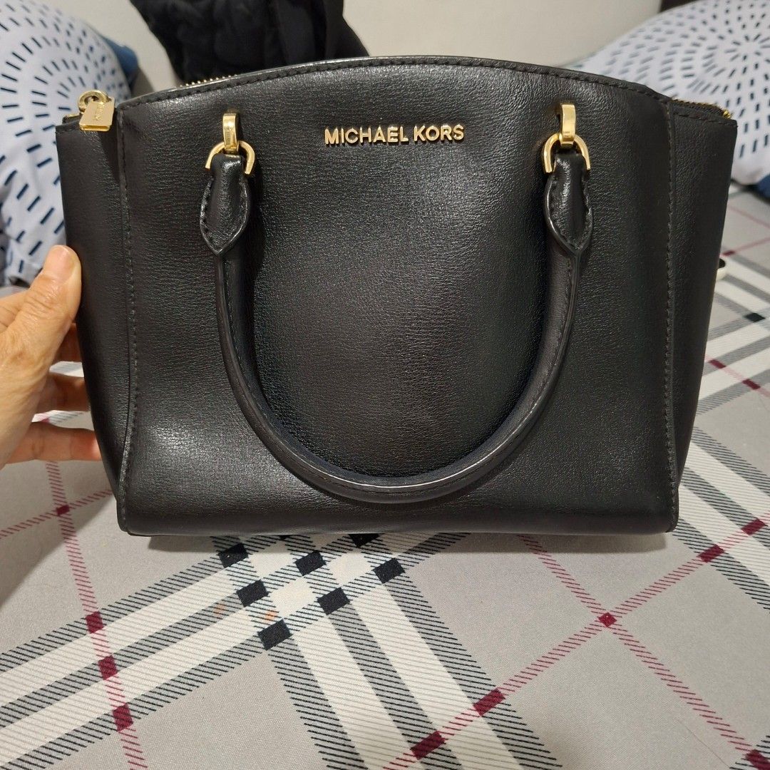 Michael Kors Black Leather Satchel Handbag (Category: Luxury Bags & Wallets) located in Imus. Submitted by jgz21 (Listing ID 1464269840, Image 2). Description: - Authentic Michael Kors black leather satchel - Elegant gold hardware details - Comfortable top handles - Includes a detachable shoulder strap for versatility - Protective feet on the bottom to prevent wear - Ample interior space for all your essentials - Ideal for both daily use and spec