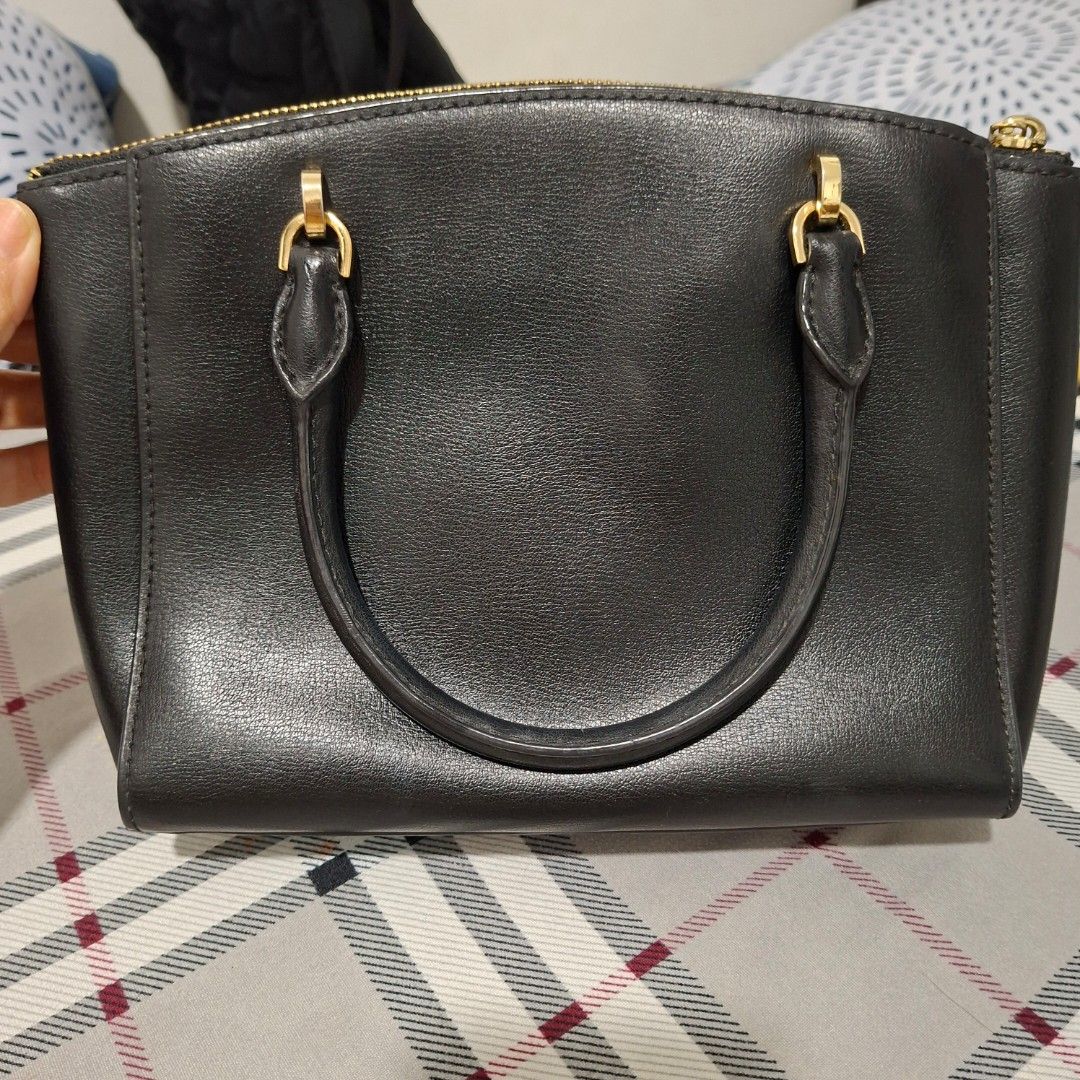 Michael Kors Black Leather Satchel Handbag (Category: Luxury Bags & Wallets) located in Imus. Submitted by jgz21 (Listing ID 1464269840, Image 3). Description: - Authentic Michael Kors black leather satchel - Elegant gold hardware details - Comfortable top handles - Includes a detachable shoulder strap for versatility - Protective feet on the bottom to prevent wear - Ample interior space for all your essentials - Ideal for both daily use and spec