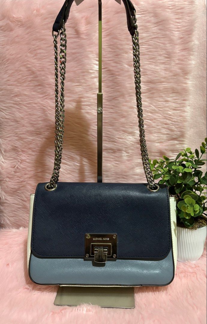 Michael Kors Colorblock Chain Shoulder Bag (Category: Shoulder Bags) located in Tuguegarao City. Submitted by closet_jz (Listing ID 1464176860, Image 2). Description: - Michael Kors shoulder bag - Colorblock design: Navy, light blue, and white - Silver-tone hardware - Secure turn-lock closure - Chain strap for shoulder wear - Multiple interior compartments - Versatile: Great for everyday or evening use.