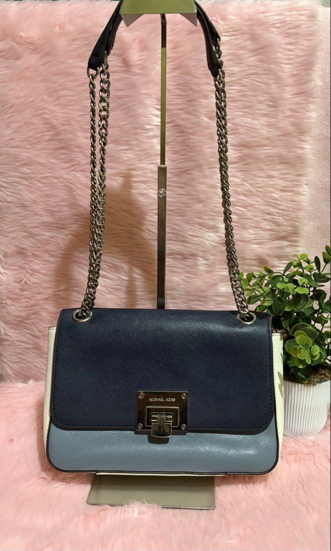 Michael Kors Colorblock Chain Shoulder Bag (Category: Shoulder Bags) located in Tuguegarao City. Submitted by closet_jz (Listing ID 1464176860, Image 1). Description: - Michael Kors shoulder bag - Colorblock design: Navy, light blue, and white - Silver-tone hardware - Secure turn-lock closure - Chain strap for shoulder wear - Multiple interior compartments - Versatile: Great for everyday or evening use.