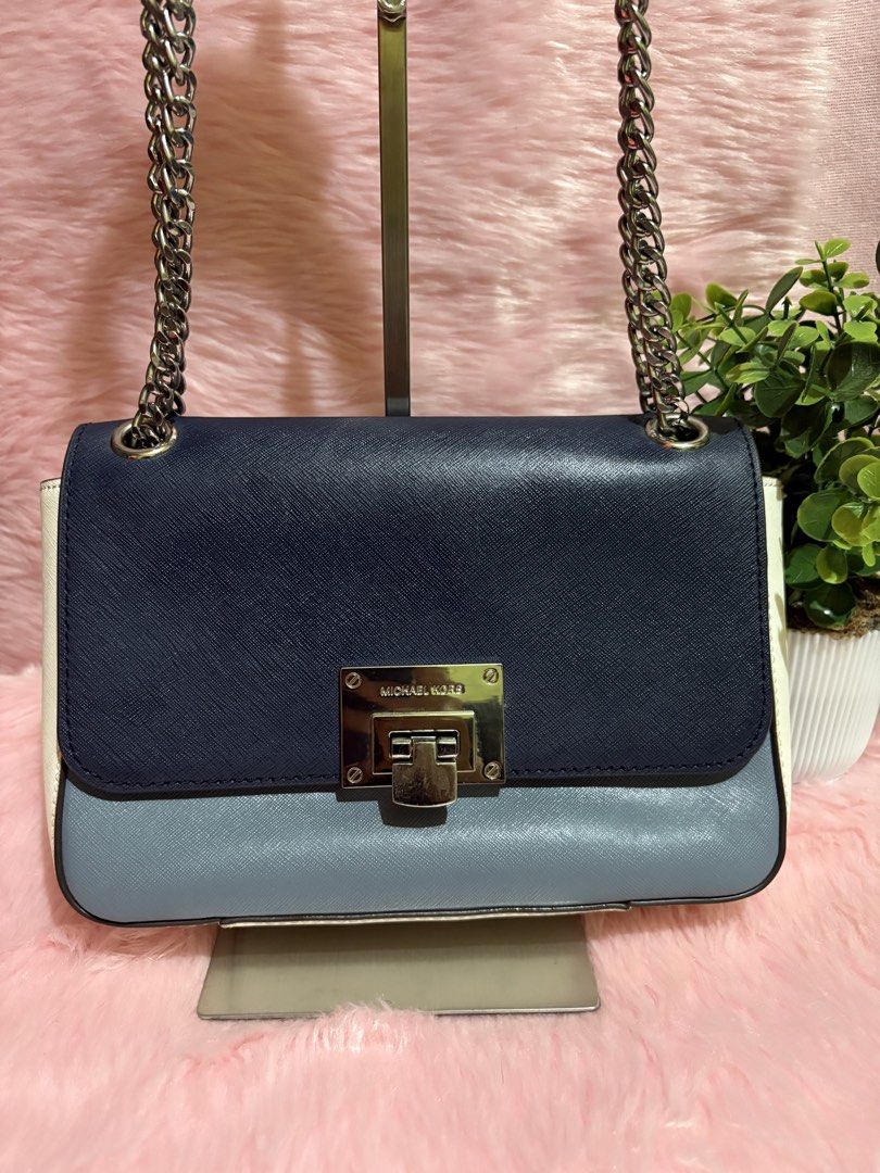 Michael Kors Colorblock Chain Shoulder Bag (Category: Shoulder Bags) located in Tuguegarao City. Submitted by closet_jz (Listing ID 1464176860, Image 3). Description: - Michael Kors shoulder bag - Colorblock design: Navy, light blue, and white - Silver-tone hardware - Secure turn-lock closure - Chain strap for shoulder wear - Multiple interior compartments - Versatile: Great for everyday or evening use.