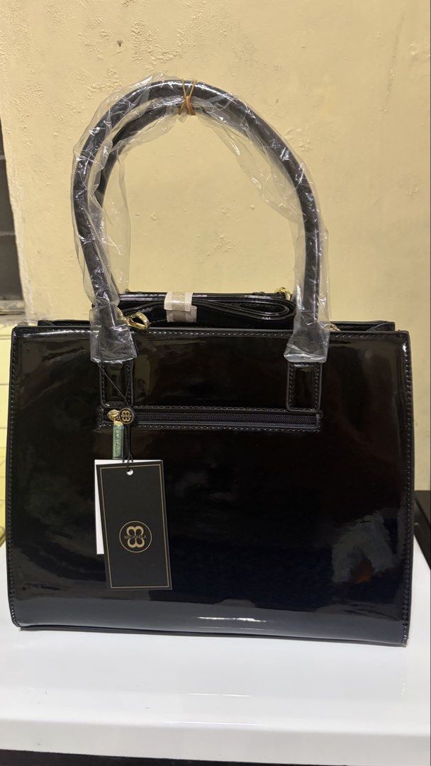 MICHAELA Black Patent Croc Tote Bag (Category: Luxury Bags & Wallets) located in Manila. Submitted by lizziedear.lizziedear (Listing ID 1464147937, Image 3). Description: - Sleek black patent leather handbag - Elegant croc-embossed trim - Polished gold hardware details - Versatile top handles and detachable shoulder strap - Convenient back pocket with zipper closure - Comes with original tags attached - Ideal for both professional settings and ev