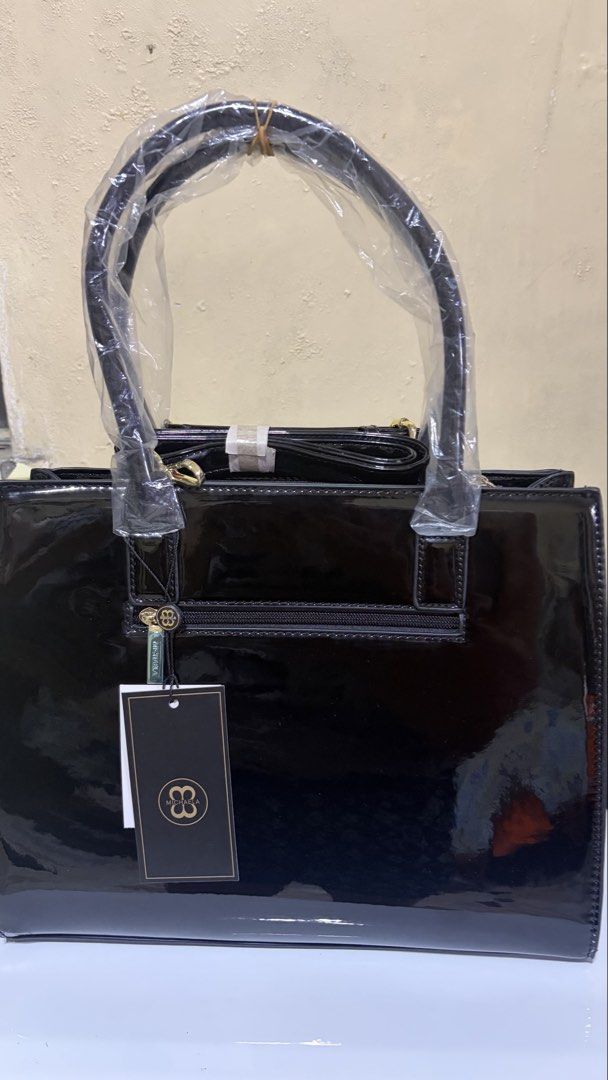 MICHAELA Black Patent Croc Tote Bag (Category: Luxury Bags & Wallets) located in Manila. Submitted by lizziedear.lizziedear (Listing ID 1464147937, Image 2). Description: - Sleek black patent leather handbag - Elegant croc-embossed trim - Polished gold hardware details - Versatile top handles and detachable shoulder strap - Convenient back pocket with zipper closure - Comes with original tags attached - Ideal for both professional settings and ev