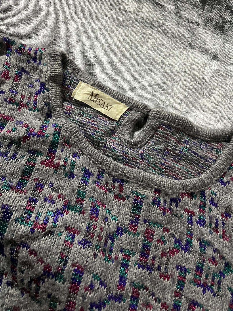 Misaki Grey Knit Sweater with Colorful Pattern (Category: Coats, Jackets and Outerwear) located in General Trias. Submitted by kevinthriftshop (Listing ID 1464289350, Image 2). Description: - Grey knit sweater from Misaki - Features a repeating pattern with hints of red, blue, and green - Crew neck, long sleeves - Ribbed cuffs and hem - Cozy and perfect for cooler weather - Great for layering or wearing on its own.