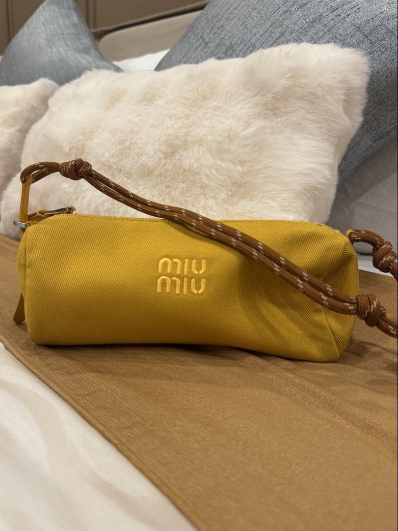 Miu Miu Gabardine Pouch (Category: Luxury Bags & Wallets) located in Manila. Submitted by love_preloveddd (Listing ID 1464201089, Image 1). Description: - Features the iconic Miu Miu logo embroidered on the front - Comes with a stylish brown and white rope strap - Secure zipper closure - Ideal for carrying your small daily essentials.