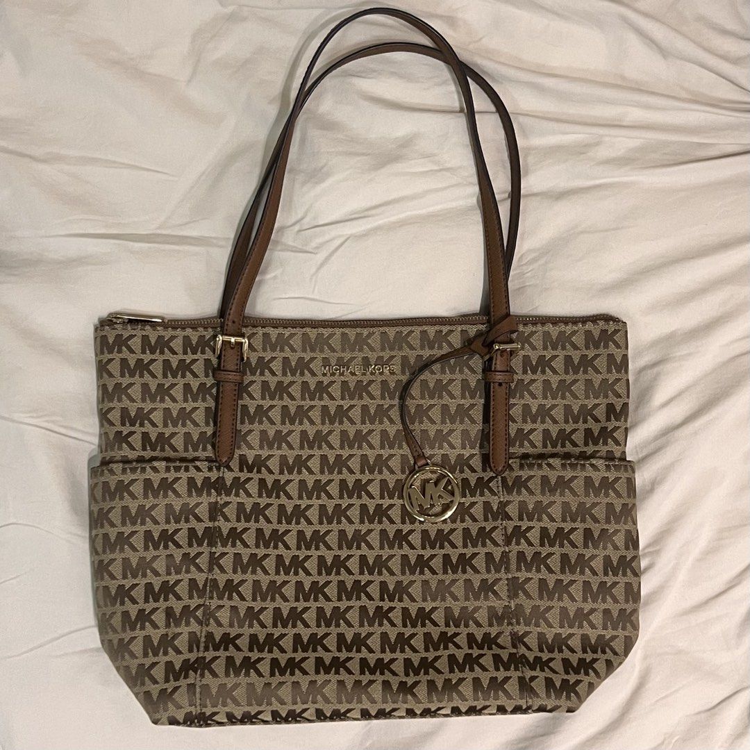 MK Tote Bag in Brown (Category: Tote Bags) located in Quezon City. Submitted by blk22 (Listing ID 1464293666, Image 1). Description: Bought in the US last December 2019 and then pandemic happened. Never used, kept in my bags cabinet only. All gold hardwares and corners are intact, no scratches, no issues. Care card and tag are still inside the bag. .