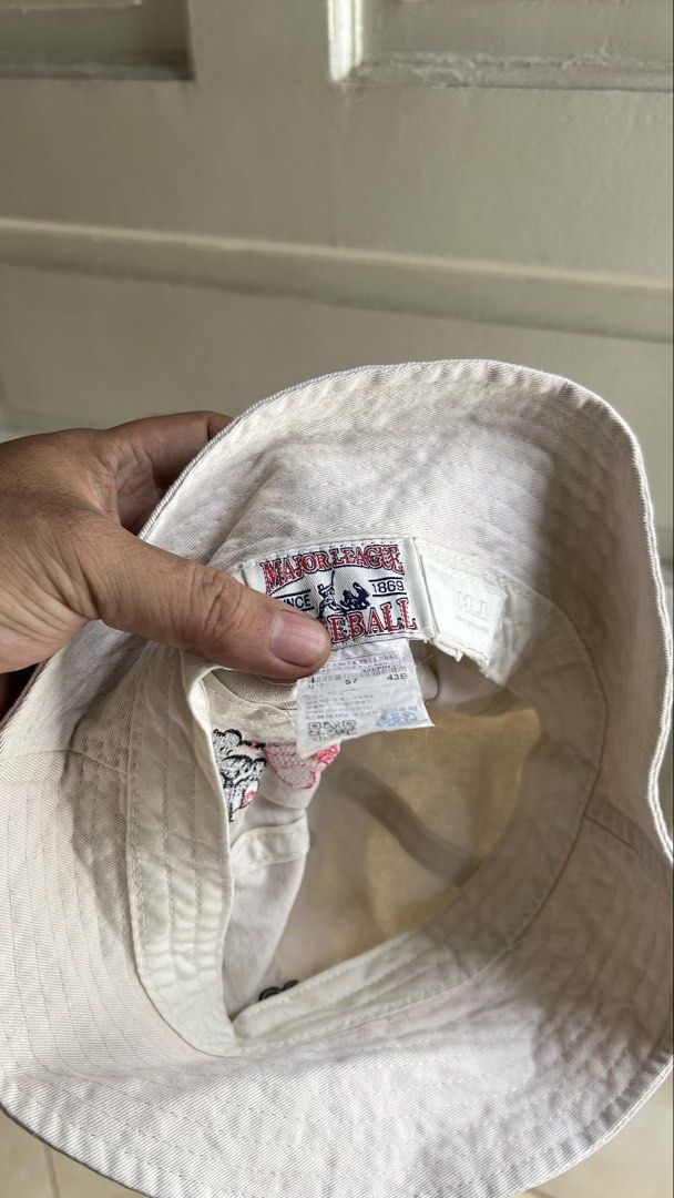 MLB Major League Baseball Bucket Hat (Category: Caps & Hats) located in General Santos City (Dadiangas). Submitted by moana_thrifts (Listing ID 1464171460, Image 3). Description: - White bucket hat with 'B' embroidery on the front. - Adorable bear graphic with a heart balloon on the side. - Includes MLB logo patch. - Made from comfortable cotton material. - Ideal for sunny weather and casual wear..