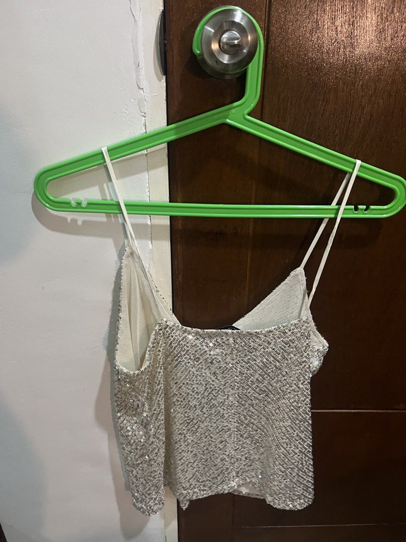 MNG Sequin Spaghetti Strap Crop Top (Category: Sleeveless) located in Pasig City. Submitted by kakerts (Listing ID 1464290122, Image 2). Description: - MNG crop top - Covered in shimmering silver sequins - Features delicate spaghetti straps - Ideal for parties, clubbing, or a night out - In great pre-loved condition - Ready for its next fabulous owner!.