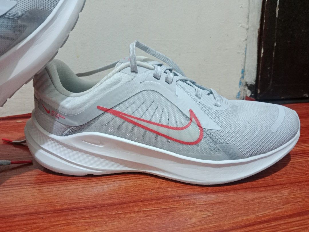 Model: Nike Quest 5 Road Running Shoes (Category: Sneakers) located in Manila. Submitted by jnnljdsgrr (Listing ID 1464265928, Image 3). Description: Model: Nike Quest 5 Road Running ShoesColorway: Pure Platinum / Light Crimson / Wolf Grey / Summit White (Style: DD9291-007 for women) Distinctive Feature: Light grey mesh upper accented with a vibrant red outlined Nike swoosh and "NIKE RUNNING EST 1972" - bought in japan - original nike - have some