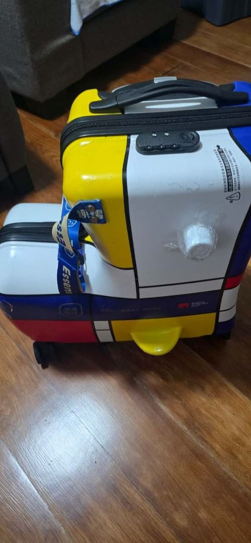 Mondrian Style Suitcase with Wheels and Lock (Category: Luggage) located in Makati City. Submitted by wesley.phvan (Listing ID 1464171269, Image 2). Description: - Unique Mondrian-inspired design (yellow, blue, red blocks) - Convenient wheels for easy transport - Built-in combination lock for security - Bright blue interior with mesh pockets and straps - Compact size: approximately 20 inches tall - Ideal for your kids to school .