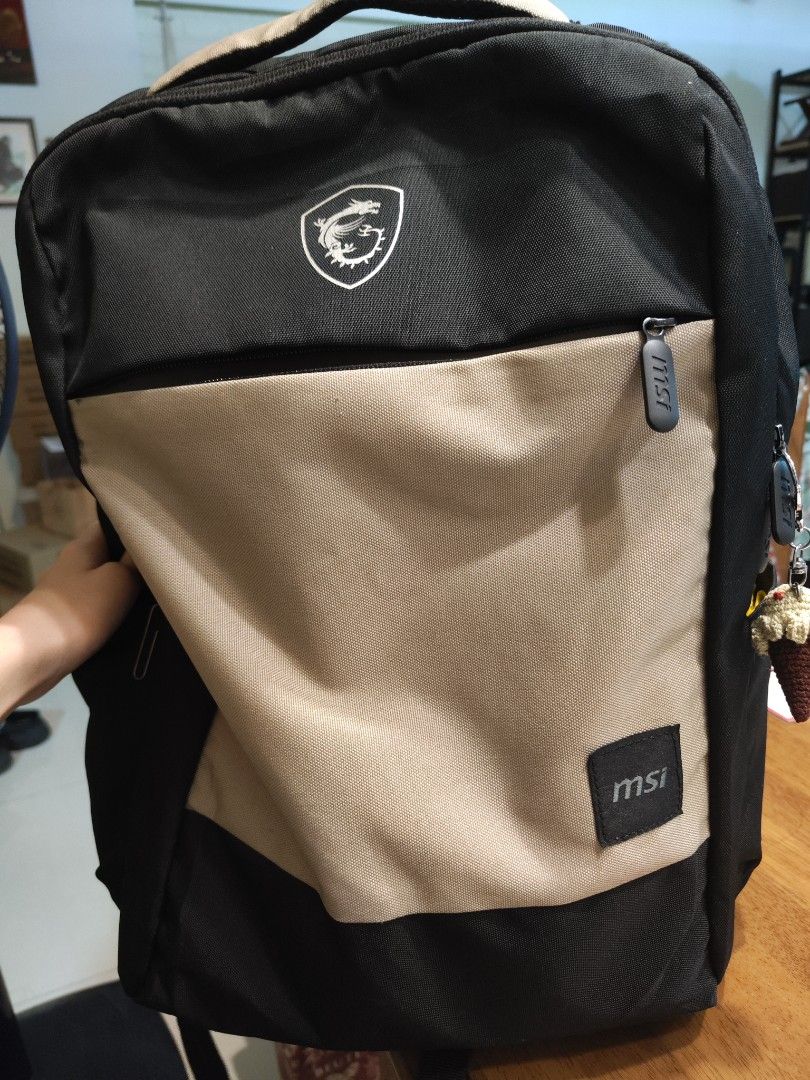 MSI Backpack (Category: Backpacks) located in Singapore. Submitted by cornelia.waldrof.bla_924 (Listing ID 1464299296, Image 1). Description: - MSI backpack in black and tan - Features iconic MSI dragon logo on the front - Zipper pull also sports the MSI logo - Perfect for carrying your laptop and daily essentials nothing wrong with the bag. I got a new bag.