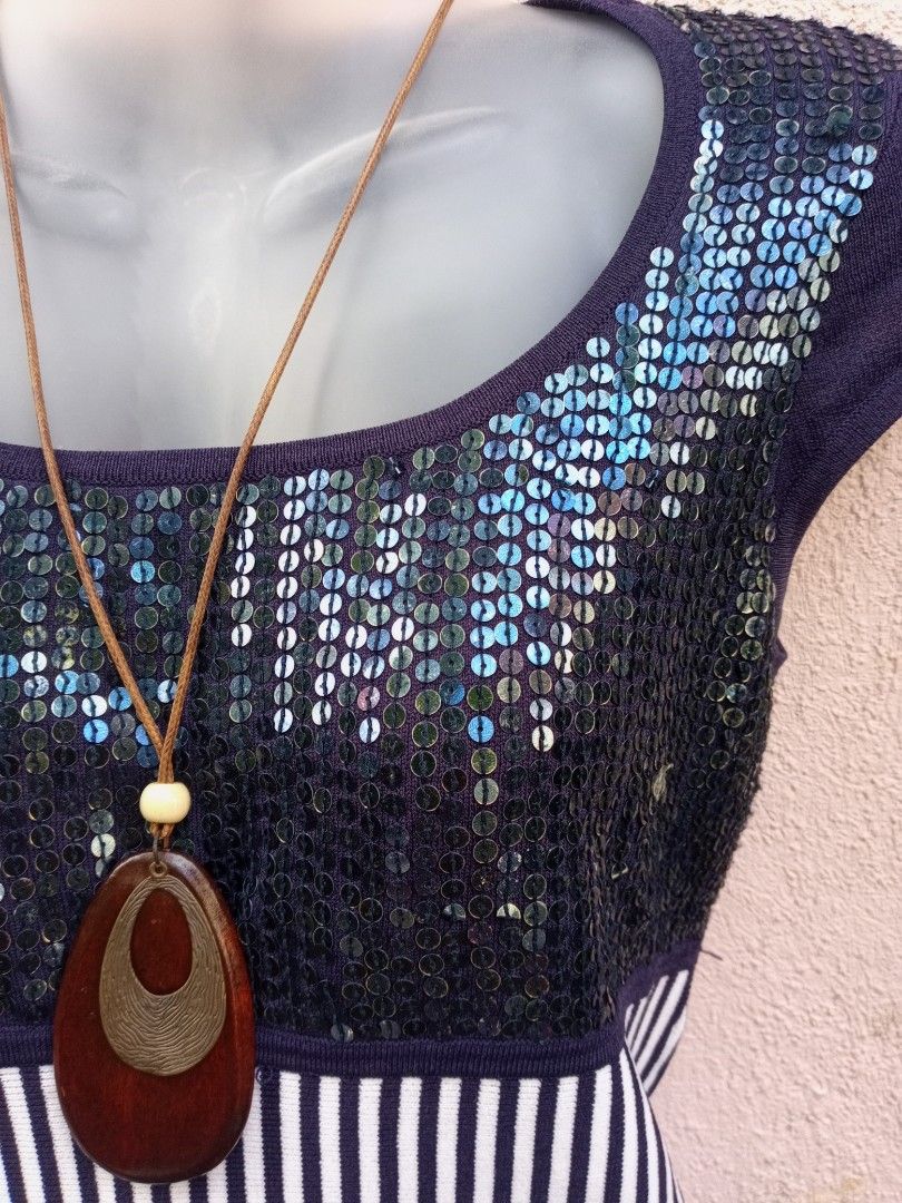 Navy Blue Striped Sequin Top (Category: Sleeveless) located in Placer. Submitted by whimsythrifts (Listing ID 1464215077, Image 2). Description: - Navy blue top - Sparkly sequin front - Contrasting white and navy stripes on bottom half - Short sleeves - Comes with a wooden pendant necklace on a cord - Perfect for casual or dressy outfits.