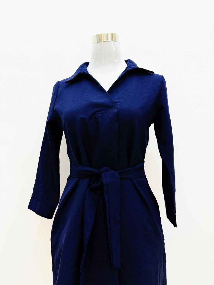 Navy Blue Wrap Dress with Belt (Category: Dresses) located in Manila. Submitted by e.louise (Listing ID 1464333053, Image 2). Description: - Chic navy blue wrap dress - Features a tie belt to cinch the waist - Elegant collar neckline - Long sleeves for added coverage - Convenient pockets included - Versatile for work or casual wear - Effortless to style for any occasion.