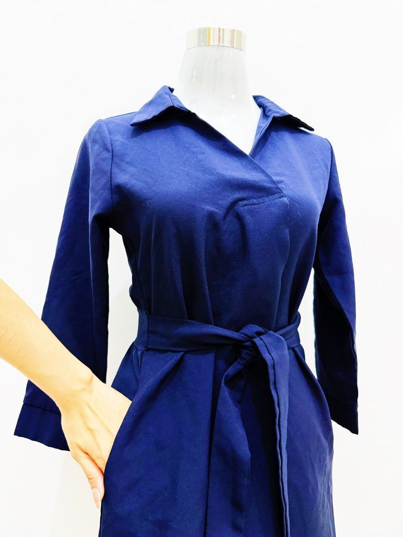 Navy Blue Wrap Dress with Belt (Category: Dresses) located in Manila. Submitted by e.louise (Listing ID 1464333053, Image 1). Description: - Chic navy blue wrap dress - Features a tie belt to cinch the waist - Elegant collar neckline - Long sleeves for added coverage - Convenient pockets included - Versatile for work or casual wear - Effortless to style for any occasion.