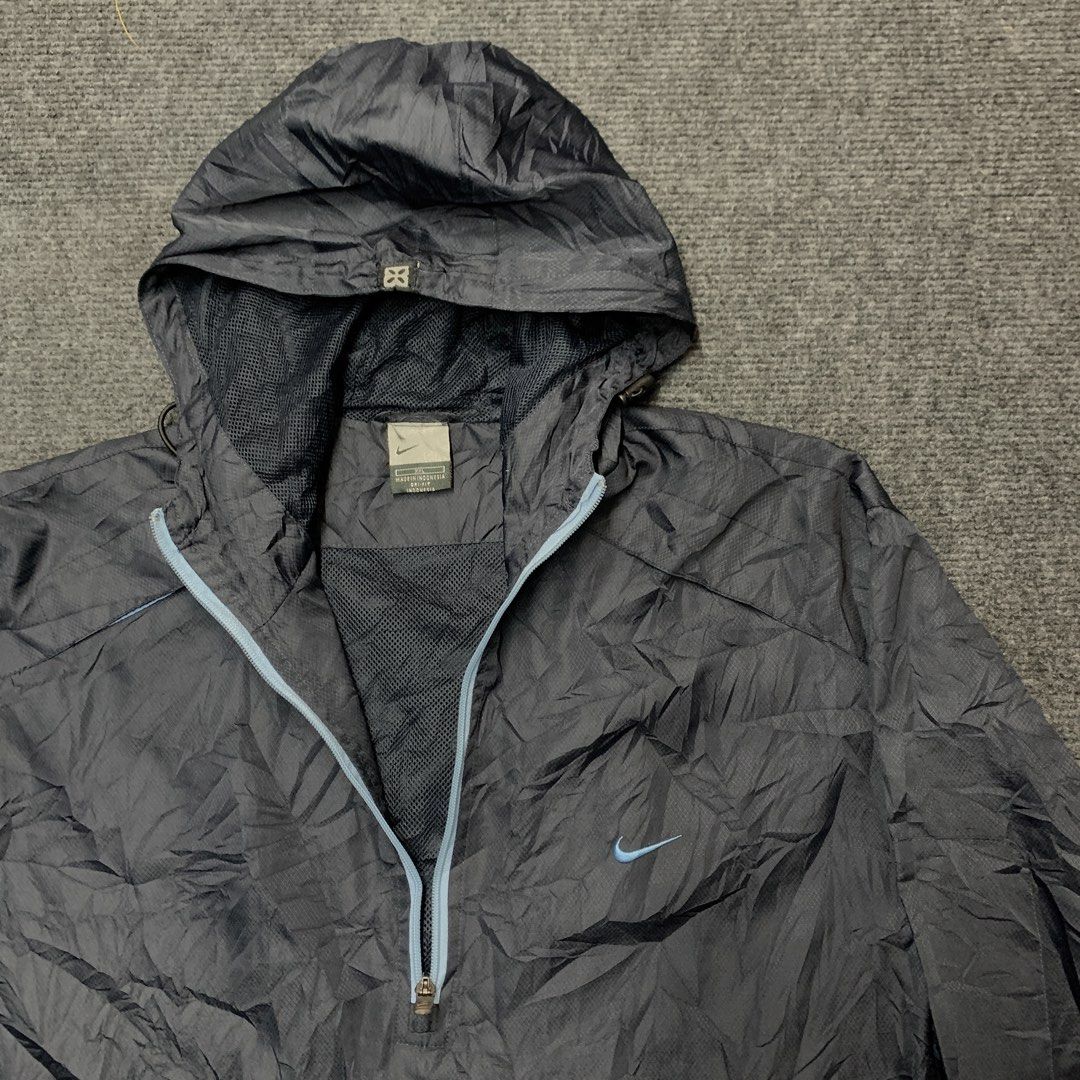 Nike Anorak Hooded Windbreaker Jacket (Category: Coats, Jackets and Outerwear) located in Imus. Submitted by la.wigginss0 (Listing ID 1464141015, Image 2). Description: - Dark grey Nike anorak jacket - Size XXL - Lightweight material, ideal for windy conditions - Features a half-zip closure - Includes a hood - Mesh lining for comfort - Made in Indonesia.