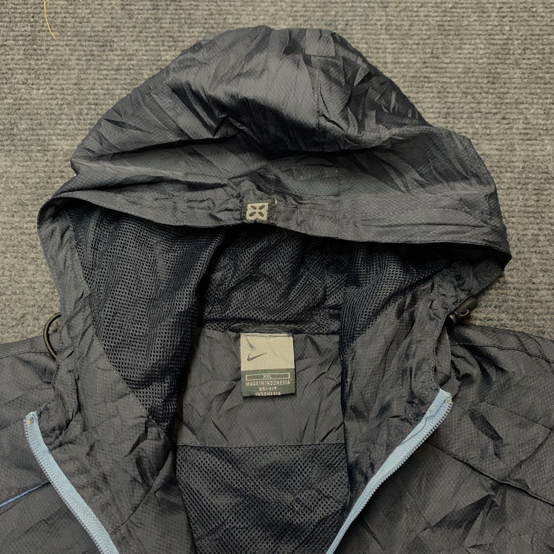 Nike Anorak Hooded Windbreaker Jacket (Category: Coats, Jackets and Outerwear) located in Imus. Submitted by la.wigginss0 (Listing ID 1464141015, Image 1). Description: - Dark grey Nike anorak jacket - Size XXL - Lightweight material, ideal for windy conditions - Features a half-zip closure - Includes a hood - Mesh lining for comfort - Made in Indonesia.