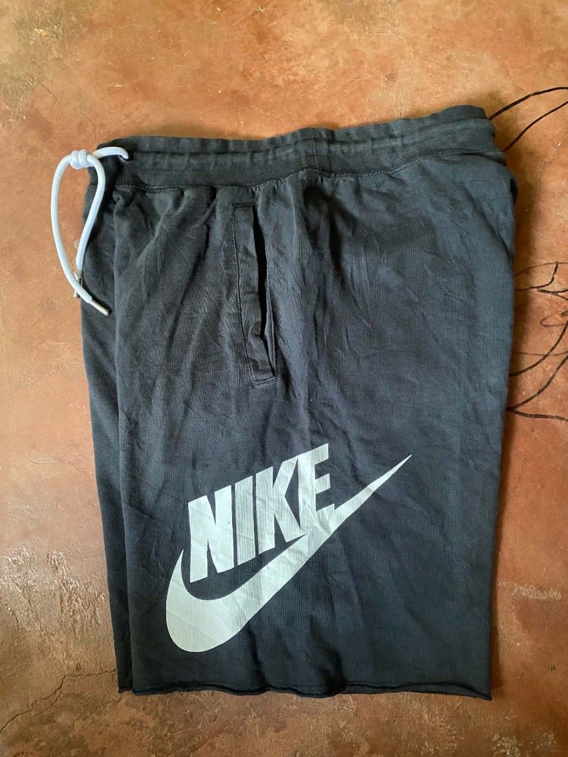 Nike Black Shorts with White Logo (Category: Shorts) located in Gumaca. Submitted by makuliti (Listing ID 1464180455, Image 1). Description: - Black Nike shorts - Large white Nike logo on leg - Elastic waistband with white drawstring - Raw hem for a casual look - Comfortable for lounging or workouts.