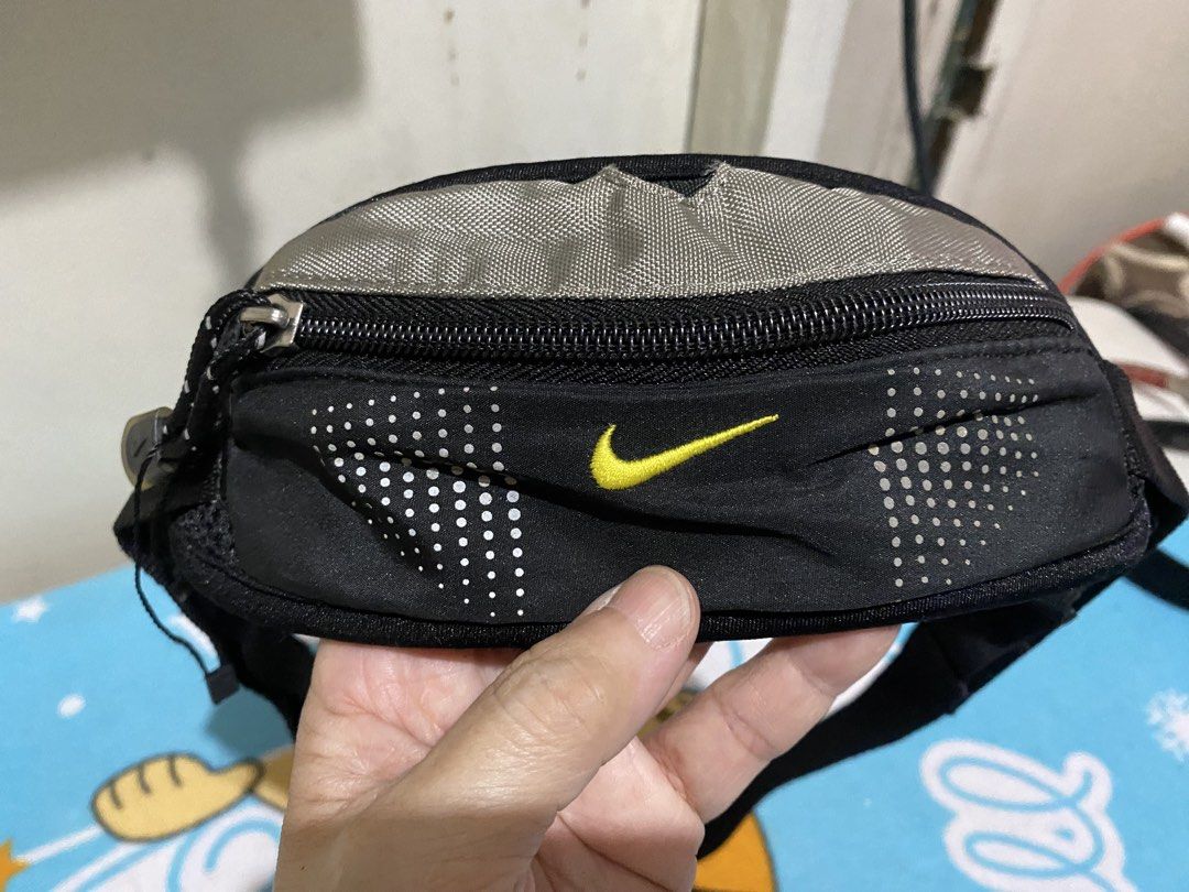 Nike Black Small Capacity Running Waist Pack (Category: Activewear) located in Manila. Submitted by resi.diaz (Listing ID 1464295370, Image 2). Description: - Nike fanny pack in black - Main zippered compartment - Adjustable strap with buckle closure - Nike swoosh logo on front and buckle - Ideal for running or travel - Comfortable, adjustable fit.