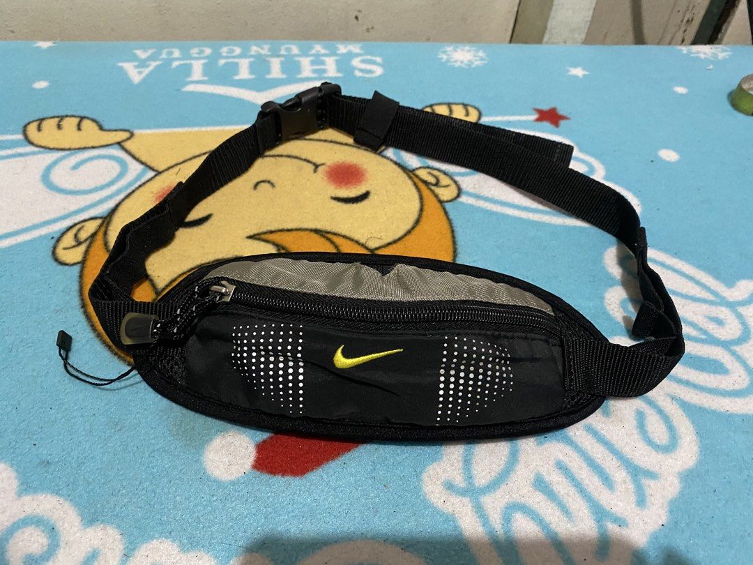 Nike Black Small Capacity Running Waist Pack (Category: Activewear) located in Manila. Submitted by resi.diaz (Listing ID 1464295370, Image 1). Description: - Nike fanny pack in black - Main zippered compartment - Adjustable strap with buckle closure - Nike swoosh logo on front and buckle - Ideal for running or travel - Comfortable, adjustable fit.