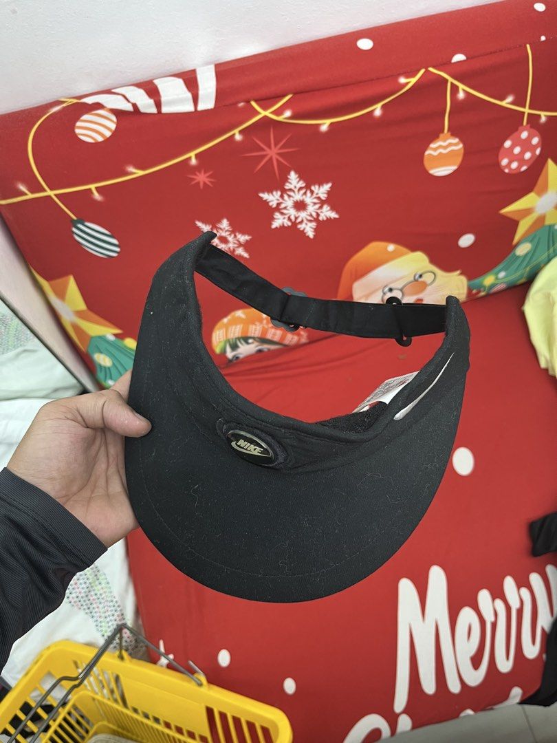 Nike Black Visor Cap Hat (Category: Caps & Hats) located in Balamban. Submitted by gogochrist09668 (Listing ID 1464165244, Image 2). Description: - Classic Nike visor - Features iconic Nike swoosh logo - Circular logo on the front - Adjustable strap at the back for a custom fit - Made in Taiwan - Ideal for sports activities or everyday casual wear.
