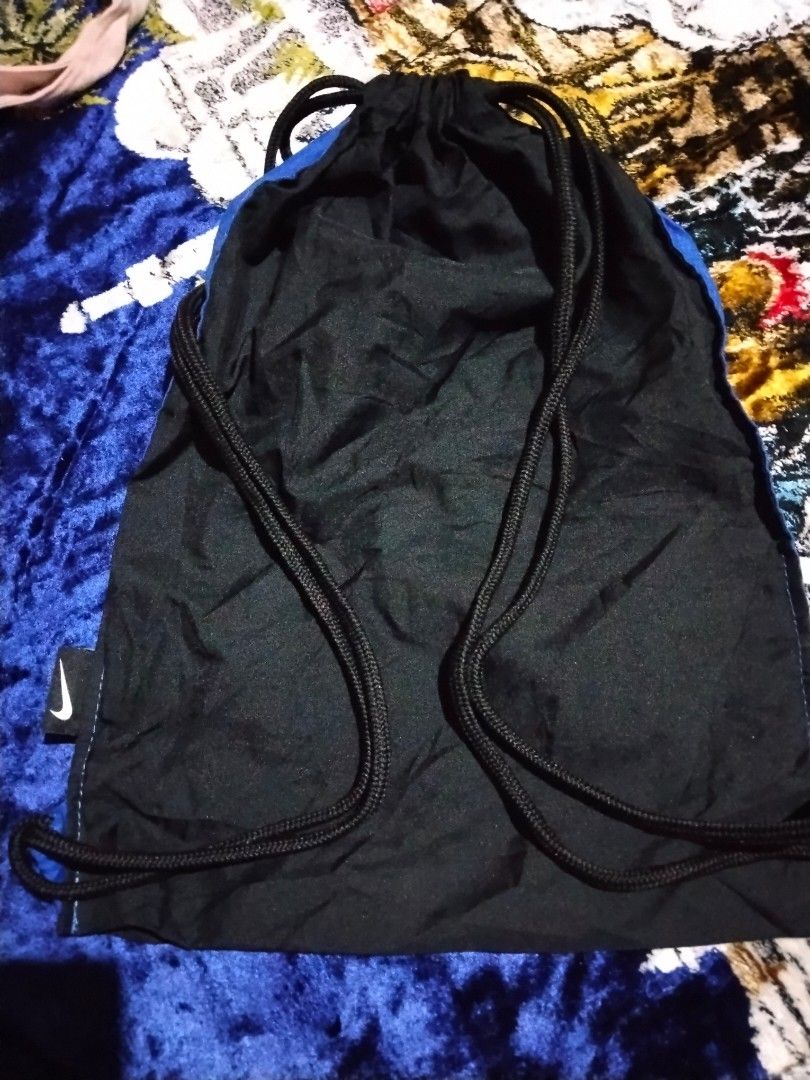 Nike Drawstring Gym Bag (Category: Backpacks) located in Mabalacat. Submitted by al_amin_thrift (Listing ID 1464229052, Image 3). Description: ✅ Authentic Nike Drawstring Gym Bag — Blue & Black Item Details - Brand: Nike — genuine, with tags & Nike logos front, back, and side tab ​ - Style: Cinch sack / drawstring backpack ​ - Color: Bright royal blue upper + black lower panel / back ​ - Material: Lightweight, durable, water-resistant nylon — qui