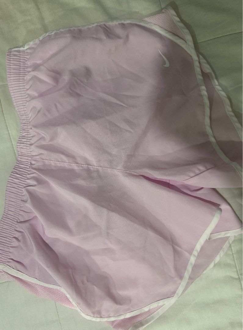 Nike Dri-FIT Pink Running Shorts (Category: Activewear) located in Manila. Submitted by decluterthings888 (Listing ID 1464337857, Image 1). Description: - Light pink Nike running shorts - Dri-FIT material for sweat-wicking - Elastic waistband with adjustable drawstring - White trim detail for a stylish look - Comfortable and breathable, ideal for workouts or casual wear BEST FIT XS- S body frame im 25 for reference.