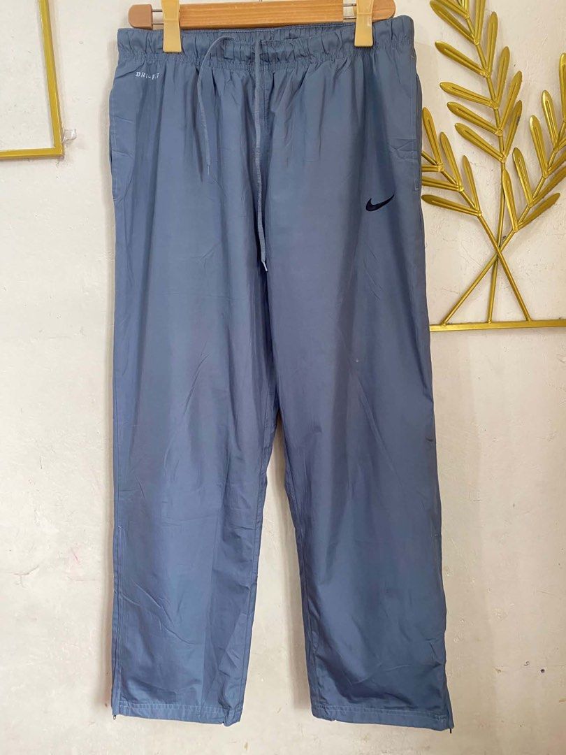 Nike Dri-FIT Track Pants Grey Size L (Category: Joggers) located in Manila. Submitted by bengirlclothing (Listing ID 1464201801, Image 2). Description: - Grey Nike track pants - Dri-FIT material for sweat-wicking comfort - Elastic waistband with adjustable drawstring - Zippers at the ankle for easy on/off - Size L - Ideal for athletic activities or everyday casual wear.