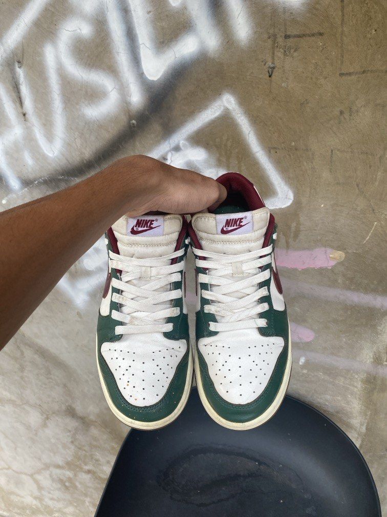 Nike Dunk Low Green Burgundy White (Category: Sneakers) located in Manila. Submitted by w1seman (Listing ID 1464165647, Image 2). Description: - Classic Nike Dunks - Low-top silhouette - Colorway: Green, burgundy, and white - Perforated toe box - White laces and midsole - Gum outsole - Ideal for everyday wear - Iconic and stylish kicks.