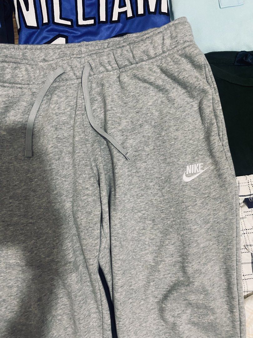 Nike Grey Jogger Sweatpants (Category: Joggers) located in Las Pinas. Submitted by johnpaul2525 (Listing ID 1464299405, Image 2). Description: - Grey Nike sweatpants - Elastic waistband with adjustable drawstring - Cuffed ankles for a snug fit - Small, iconic Nike logo on the left leg - Versatile: Ideal for lounging, workouts, or casual wear - Easy to style with any t-shirt or hoodie.