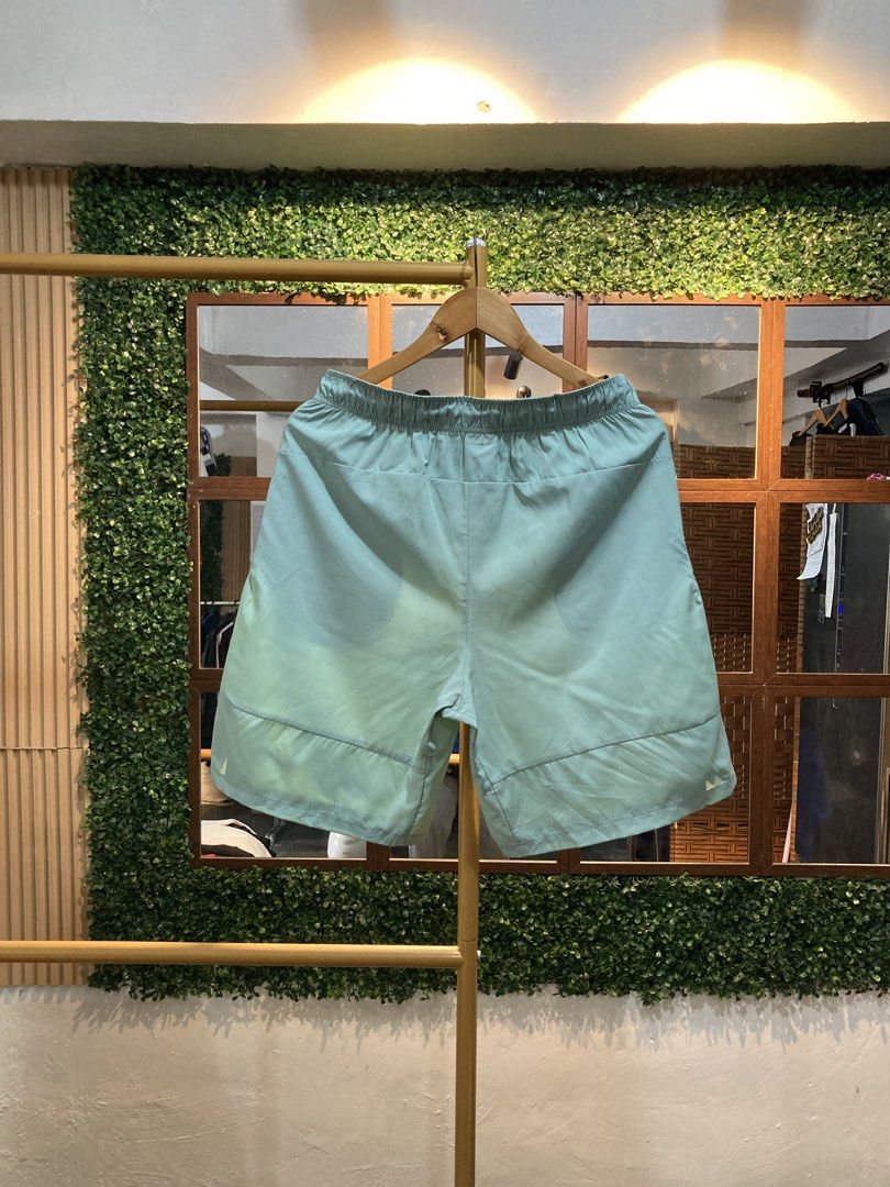 Nike Men's Running Shorts Light Green (Category: Shorts) located in Trece Martires City. Submitted by thriftkoto.91 (Listing ID 1464217493, Image 2). Description: - Light green Nike running shorts - Elastic waistband with drawstring - Two side pockets - Small Nike logo on left leg - Comfortable and breathable material - Ideal for workouts or casual wear.