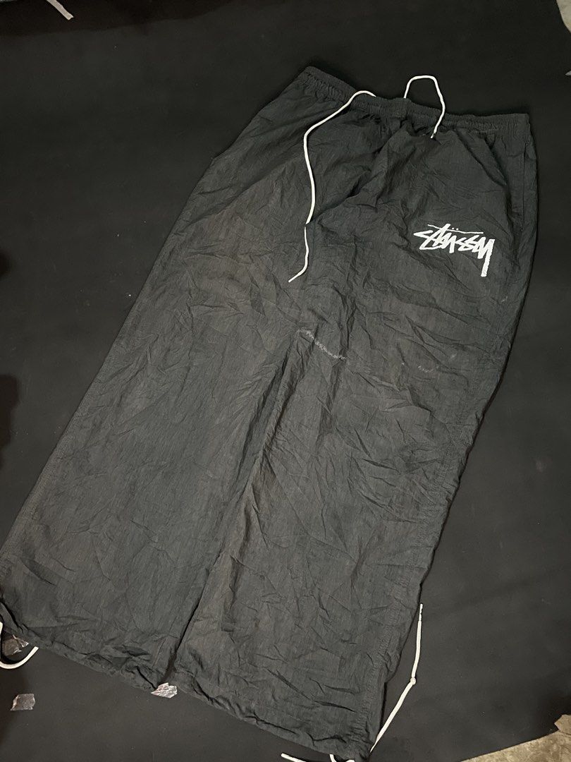 Nike Stussy Track Pants (Category: Joggers) located in Cebu City. Submitted by grand_kian (Listing ID 1464279548, Image 1). Description: Black track pants with Nike and Stussy branding. Elastic waistband with drawstring. Adjustable cuffs. Great for casual wear or sports..