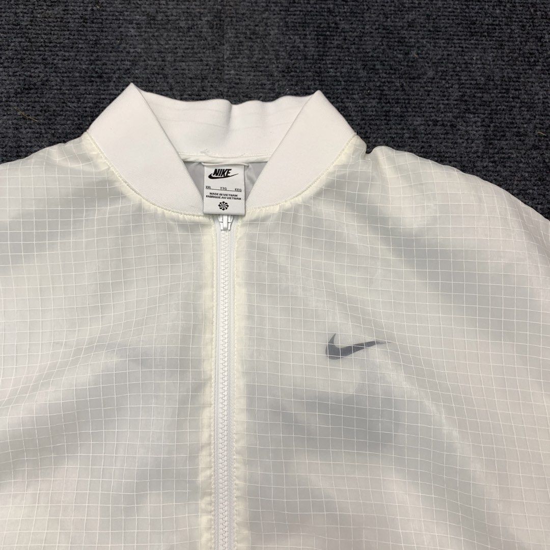 Nike White Grid Bomber Jacket XXL (Category: Coats, Jackets and Outerwear) located in Imus. Submitted by la.wigginss0 (Listing ID 1464140765, Image 3). Description: - White Nike bomber jacket - All-over grid pattern - Sheer sleeves - Large Nike logo on the back - Zipper closure - Ribbed cuffs and hem - Made in Vietnam.