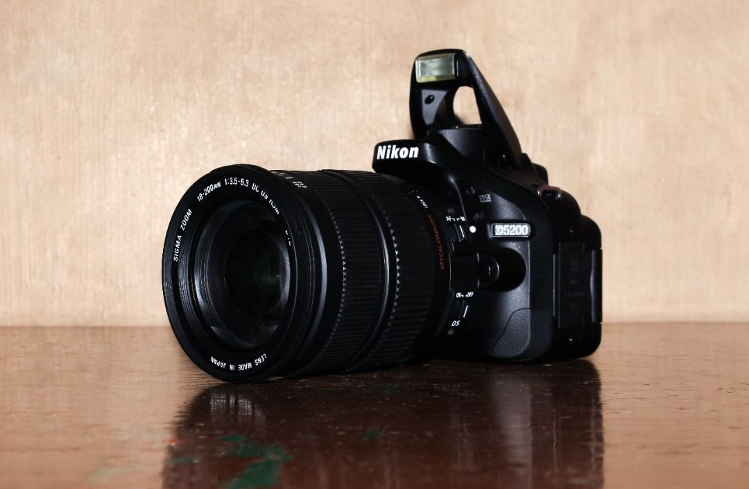 Nikon D5200 24.1mp Camera with Sigma 18-200mm Lens (Category: Cameras) located in Marikina City. Submitted by kristianity-ph (Listing ID 1464282984, Image 1). Description: Selling my personal Nikon D5200 DSLR camera with a versatile Sigma 18-200mm lens. Good for beginners, students, everyday photography, travel, and content creation. ✅ Key Specs: • 24.1MP DX-format CMOS Sensor • EXPEED 3 Image Processor • Full HD 1080p Video Recording • 39-Point 