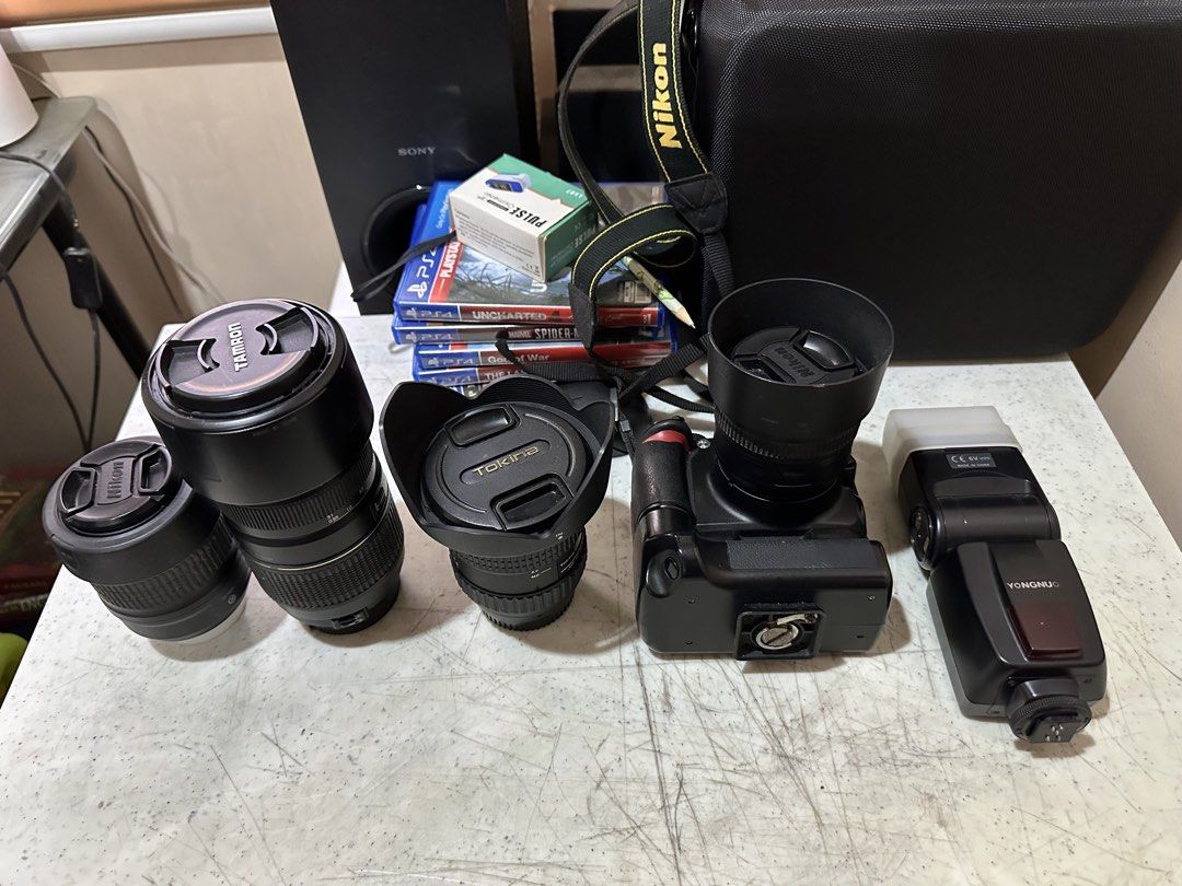 Nikon DSLR Camera with Lenses, Flash, and Battery Grip (Category: Cameras) located in Manila. Submitted by olxph_jeffr6014 (Listing ID 1464140801, Image 3). Description: - Nikon DSLR Camera D3100 - Tamron Lens - Tokina Lens - Yongnuo Flash - Battery Grip - 2 x Nikon Memory Cards - Original Nikon Strap - Ideal for photography enthusiasts.