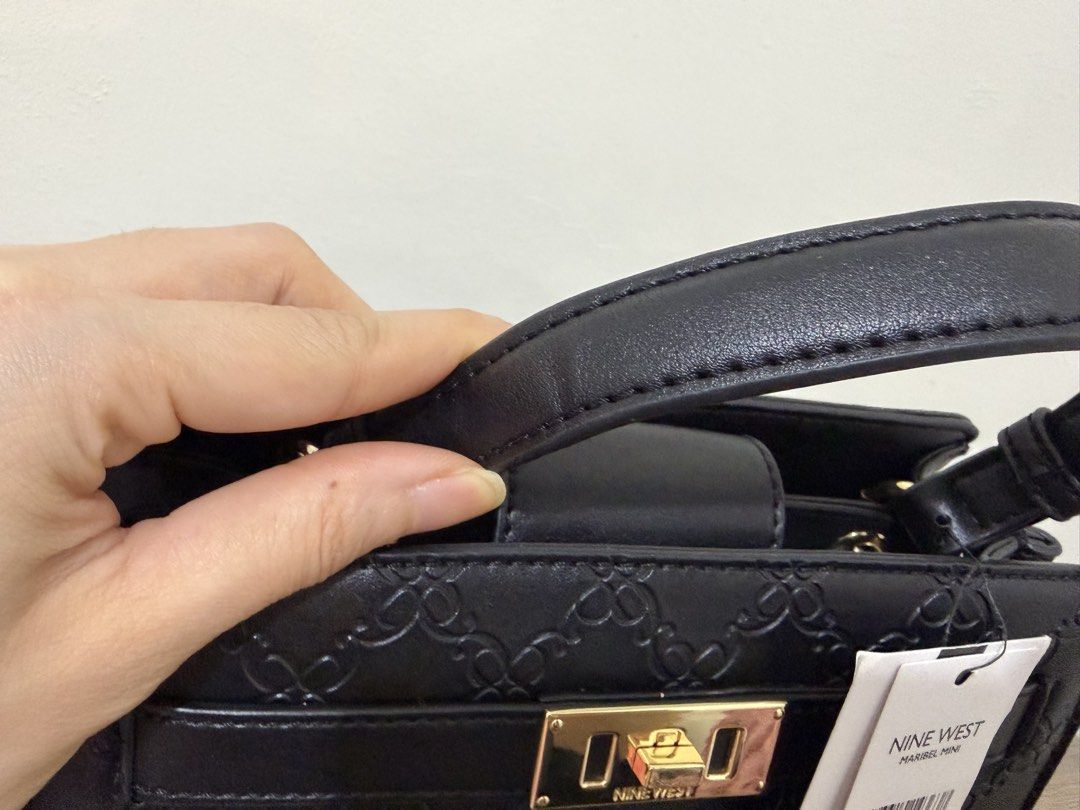 Nine West Maribel Mini Black Monogram Top Handle Bag (Category: Luxury Bags & Wallets) located in Magalang. Submitted by xeevain (Listing ID 1464308374, Image 3). Description: - Brand new Nine West Maribel Mini bag - All-over Nine West monogram pattern - Top handle and detachable shoulder strap - Elegant gold hardware details - Includes original tag - Lined interior with a central compartment -Take note that there is a minimal crease on the handl