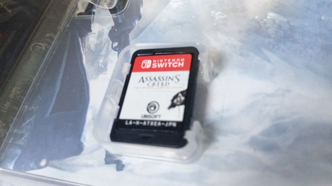 Nintendo Switch Console with Games and complete Accessories (Category: Nintendo) located in Caloocan City. Submitted by wifiskelly (Listing ID 1464214128, Image 2). Description: - Nintendo Switch Console - Original Box Included - Official Dock - Blue and Red Joy-Cons - AC Adapter - Assassin's Creed Game Cartridge - Cooling Fan Attachment - Screen displays game library and The Legend of Zelda: Breath of the Wild - Ideal for both home and on-the-go