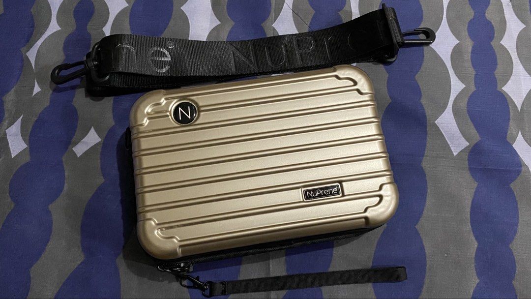 NuPrene Gold Hard Shell Cosmetic Case with Strap (Category: Luxury Bags & Wallets) located in Manila. Submitted by https.kieo (Listing ID 1464139050, Image 1). Description: - Gold hard shell cosmetic case by NuPrene - Spacious main compartment - Detachable shoulder strap included - Small wrist strap also included - Ideal for travel or organizing makeup - Clean interior - Ready for its new owner.
