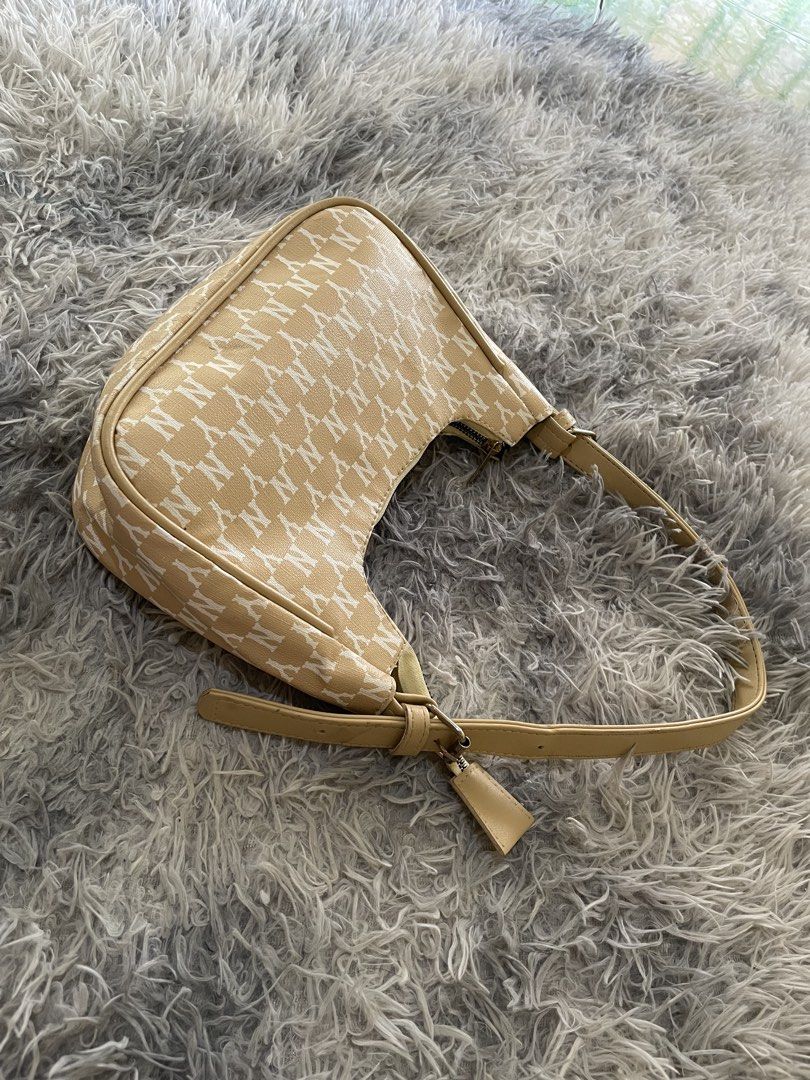 NY Yankees Monogram Shoulder Bag (Category: Shoulder Bags) located in Manila. Submitted by khen23_408 (Listing ID 1464160367, Image 3). Description: - Cute NY Yankees monogram shoulder bag - Beige and white colorway - Zipper closure - Adjustable strap - Great for everyday use - Fits essentials.