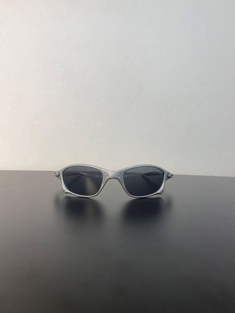 Oakley Juliet (Category: Sunglasses & Eyewear) located in Manila. Submitted by mine2ownit (Listing ID 1464227815, Image 1). Description: - Sleek silver frame - Dark, classic lenses - Timeless design, perfect for daily wear.