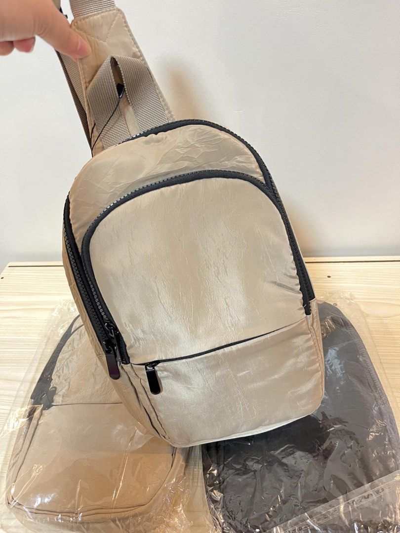 OAXS Nylon Sling Bag - Beige (Category: Cross-body Bags) located in Paranaque City. Submitted by sissyloveph (Listing ID 1464287386, Image 1). Description: - Lightweight nylon sling bag - Two main zippered compartments - Front pocket with a smaller zip - Padded mesh back for comfort - Adjustable strap with metal clasp - Ideal for everyday use.