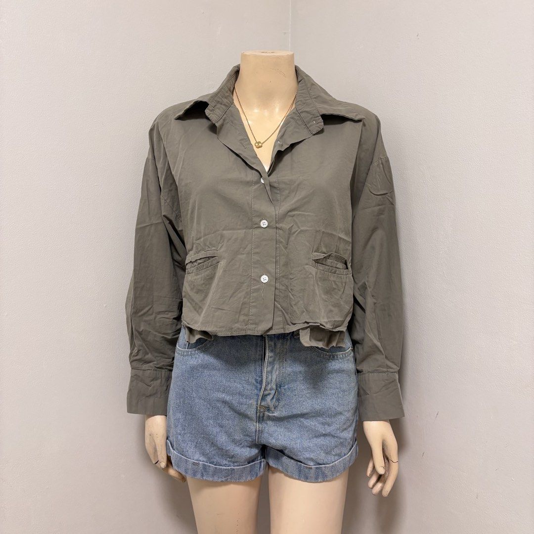 Olive Green Cropped Buttondown Polo (Category: Blouses) located in Imus. Submitted by reloved.nd (Listing ID 1464261057, Image 1). Description: - Olive green cropped shirt - Collared neckline - Two front pockets with button closures - Long sleeves with button cuffs - Versatile for casual or dressed-up looks.