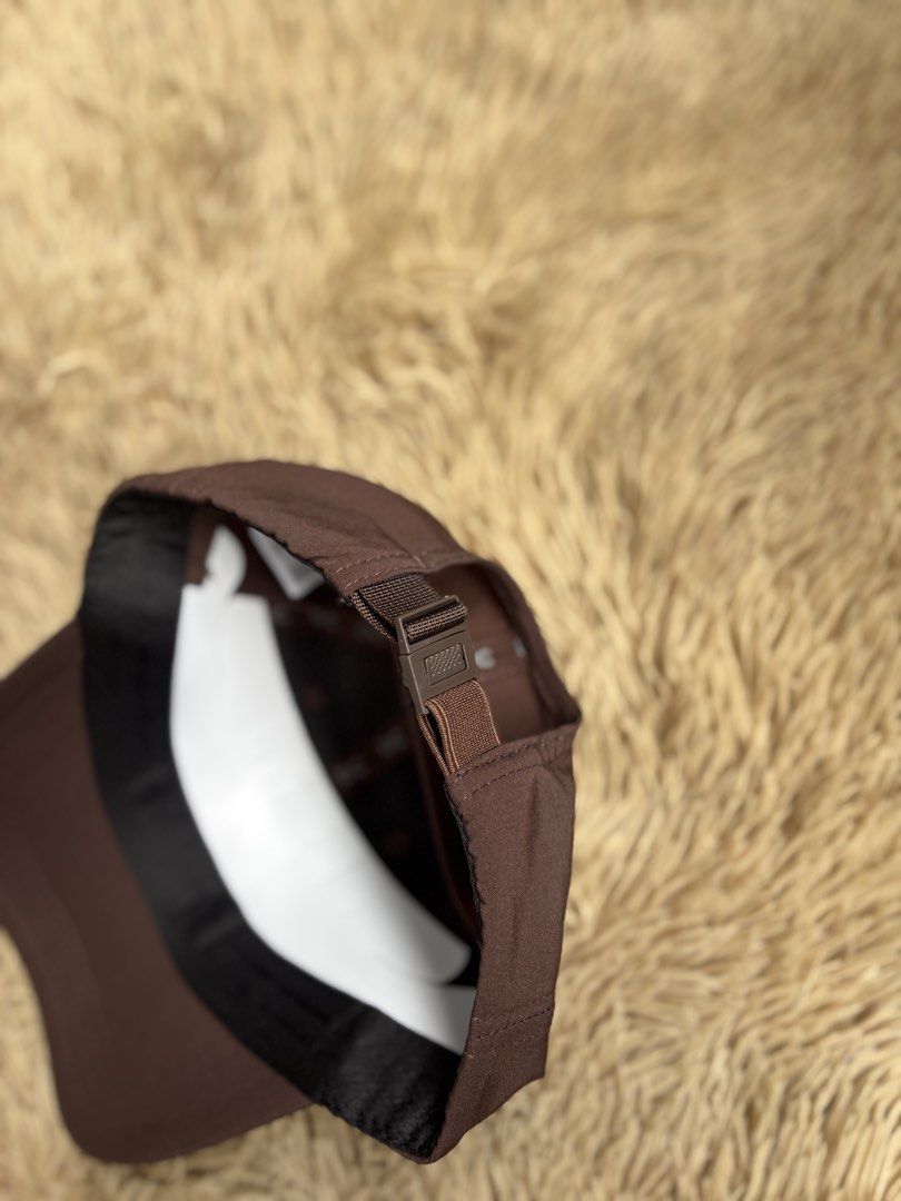 On Running Cap Brown (Category: Caps & Hats) located in Quezon City. Submitted by nojthrift (Listing ID 1464252090, Image 3). Description: - Brand: On Running - Color: Brown - Design: Simple with white logo on the front - Features: Adjustable strap at the back for a customized fit - Versatile: Ideal for everyday wear or sports activities - Style: Clean and classic look.