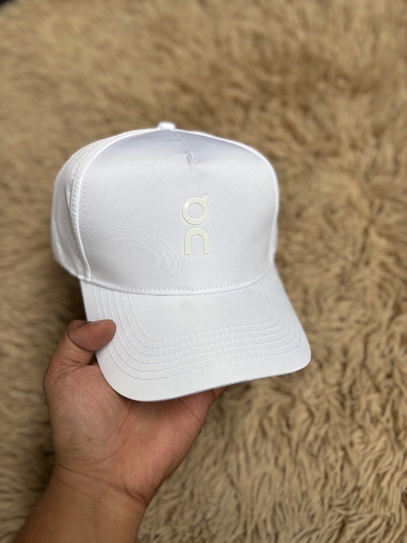 ON Running White Cap (Category: Hats & Beanies) located in Quezon City. Submitted by nojthrift (Listing ID 1464252644, Image 2). Description: - White ON Running Cap - Perforated sides for enhanced breathability - Adjustable strap at the back for a customized fit - Clean and simple design - Perfect for running or everyday casual wear.