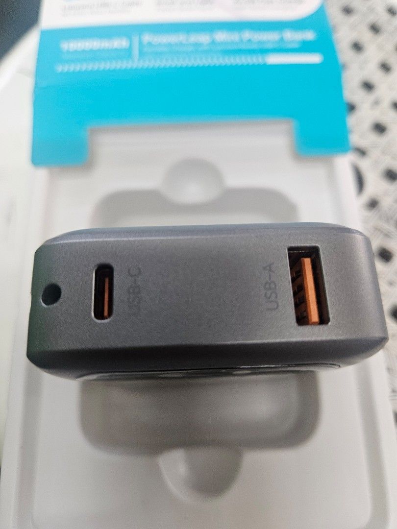 Original Choetech 10000Mah fast charging with cable strap (Category: Batteries & Power Banks) located in Pasay City. Submitted by son_castor (Listing ID 1464260739, Image 3). Description: “Create a premium, realistic product advertisement using the uploaded CHOETECH PowerLeap Mini image as the exact visual reference. Keep the CHOETECH branding, product design, gray color, built-in lanyard USB-C cable, digital battery display, USB-C and USB-A port