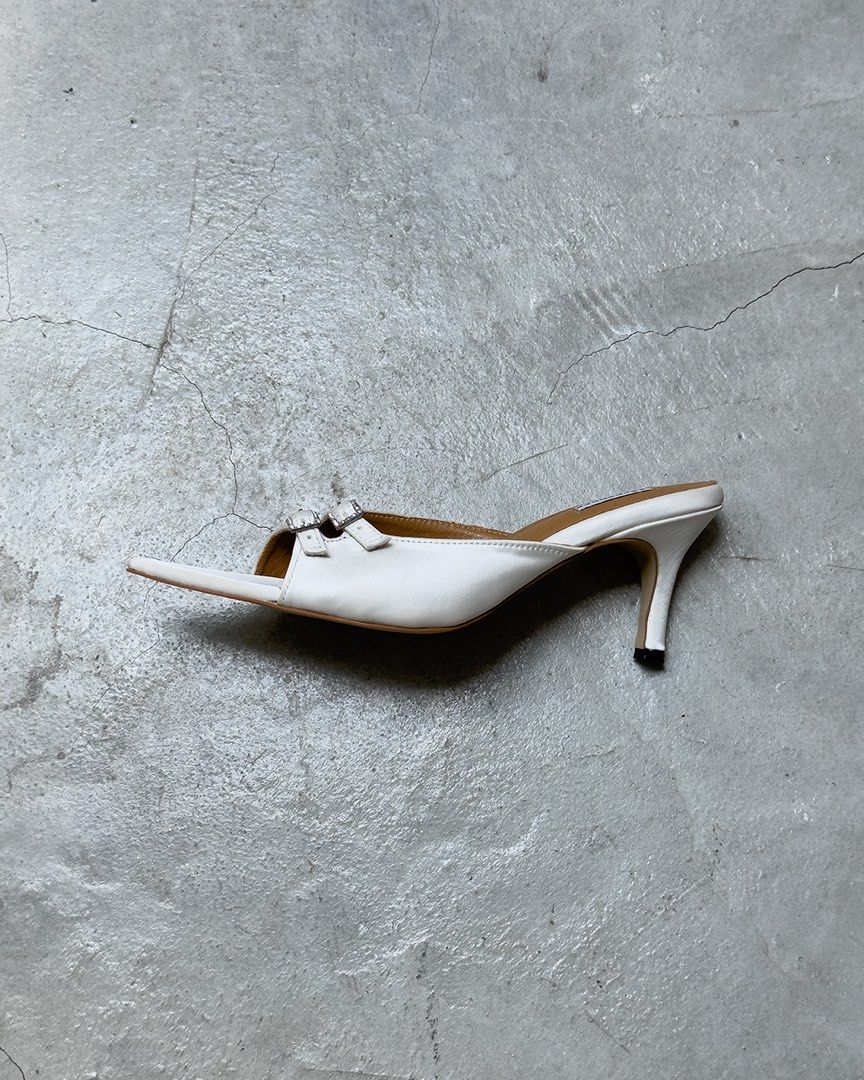 Pace Shoes from BKK - Trixie in White (Category: Heels) located in Quezon City. Submitted by najamazing (Listing ID 1464195909, Image 2). Description: - Brand: Paceshoes - Style: White pointed toe mules - Features: Double buckle detail at the front, slip-on style - Heel: 2 inches - Comfort: Comfortable for everyday wear - Includes: Original box - Original Price: $185 including shipping fee.