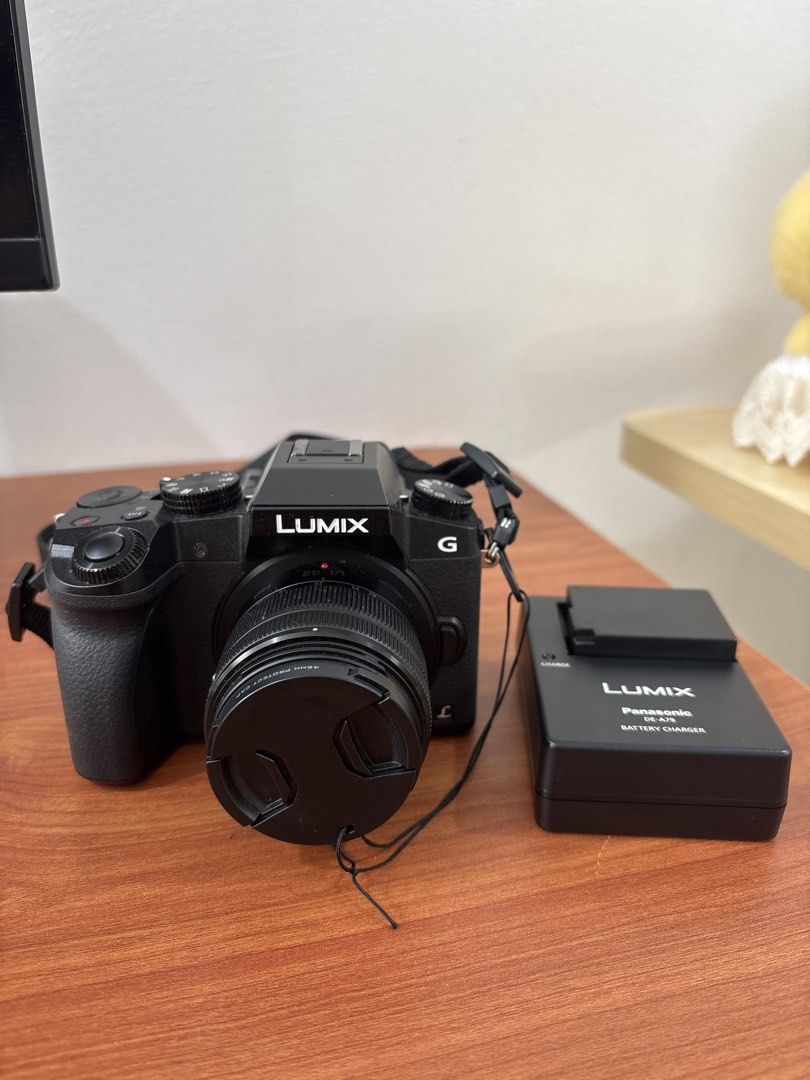 Panasonic Lumix G Mirrorless Camera with Lens (Category: Cameras) located in Quezon City. Submitted by mynameismio (Listing ID 1464158256, Image 1). Description: - Panasonic Lumix G camera - Includes lens - Comes with battery charger - Ideal for both photos and videos - Ready to capture your moments - Attached strap - Lens cap included.