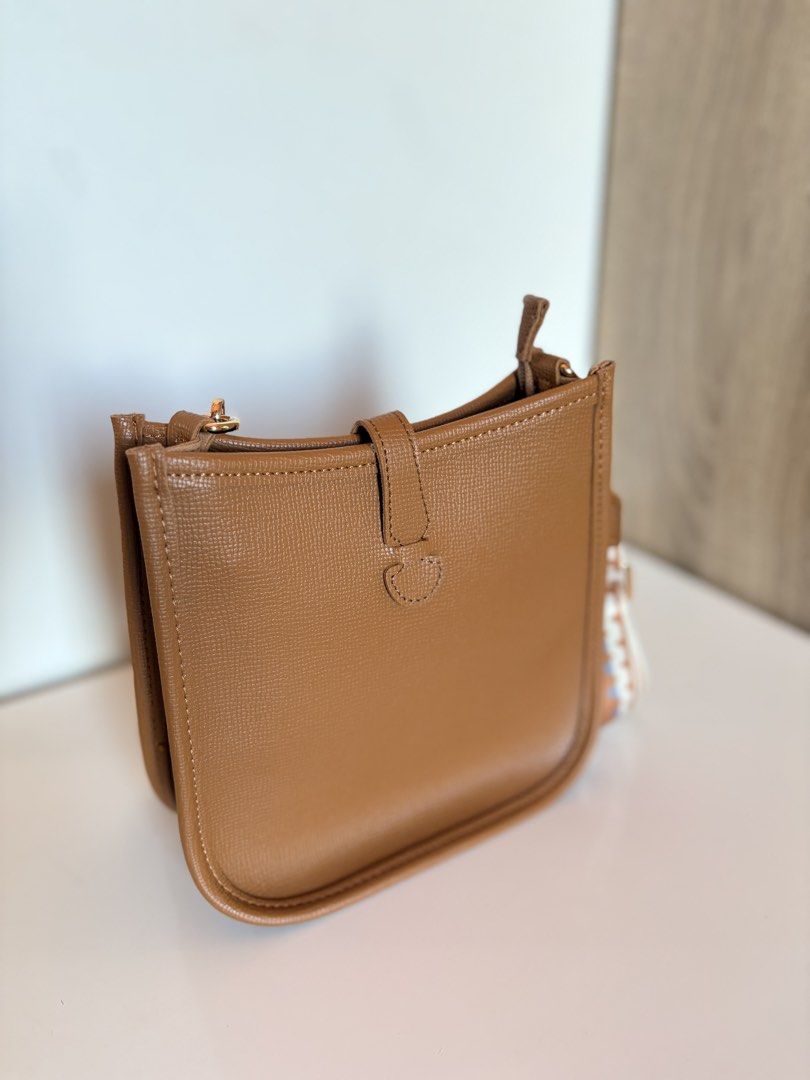PARISIAN Tan Crossbody Bag with Patterned Strap (Category: Cross-body Bags) located in Taal. Submitted by aliafrncsca (Listing ID 1464162718, Image 3). Description: - Parisian tan crossbody bag - Detachable patterned strap included - Main compartment with interior zip pocket - Magnetic snap closure on front flap - Elegant gold hardware details - Ideal for everyday wear.