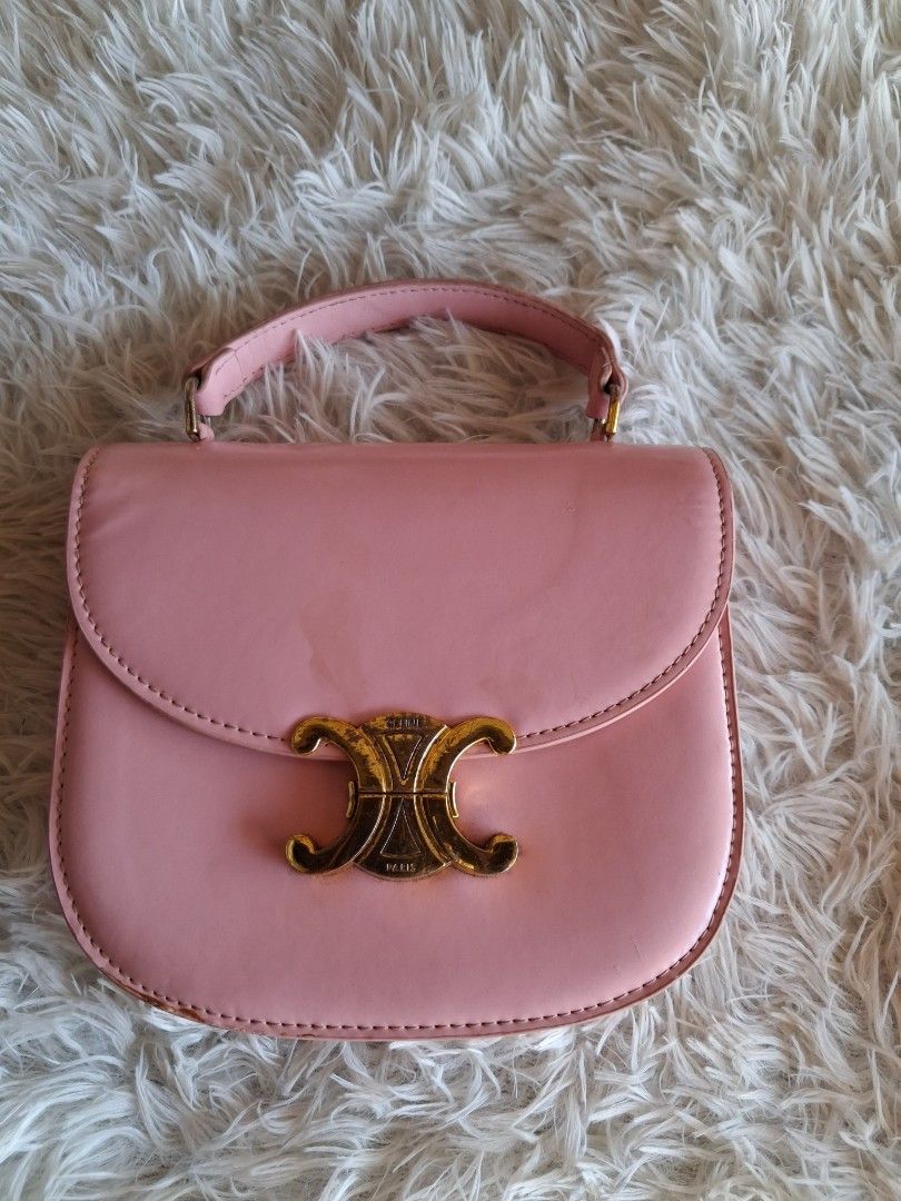 Pink Celine Triomphe Bag (Category: Luxury Bags & Wallets) located in Agoncillo. Submitted by vinsoy07 (Listing ID 1464163732, Image 1). Description: - Cute pink handbag - Elegant gold hardware - Iconic Triomphe clasp - Interior zip pocket for secure storage - Approximately 7 inches tall - Ideal for carrying your daily essentials - Selling because it's no longer frequently used.