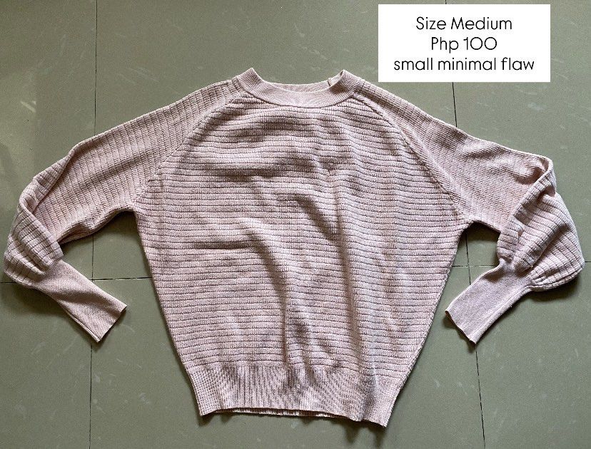 Pink Knit Sweater Size Medium Minimal Flaw (Category: Coats, Jackets and Outerwear) located in Imus. Submitted by theninetiesboxph (Listing ID 1464260986, Image 1). Description: - Pink knit sweater - Size: Medium - Textured horizontal stripe pattern - Slight puff sleeve detail - Small flaw on front (refer to close-up photo) - Price: Php 100.